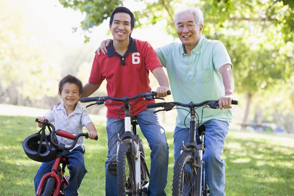 Grandfather son and grandson bike riding